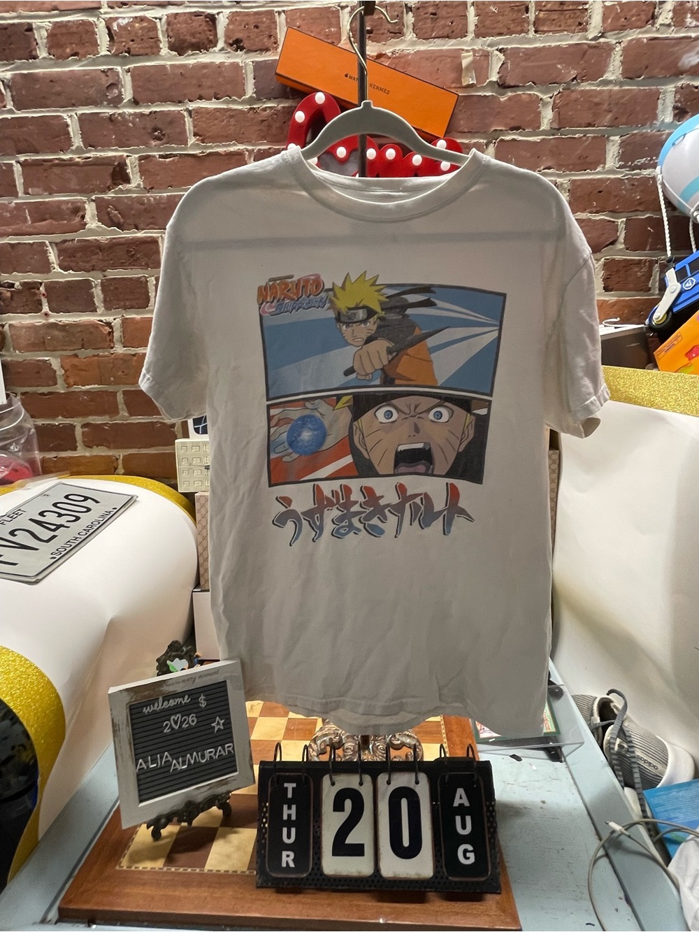 white Naruto Shippuden graphic t-shirt featuring split panels of Naruto Uzumaki
